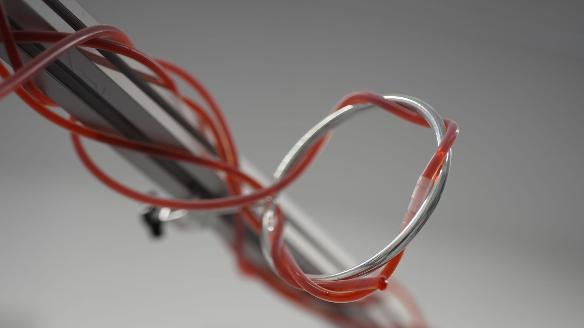 Epimetheus by Januš Suša — red tubing and a steel ring threaded around an aluminium frame